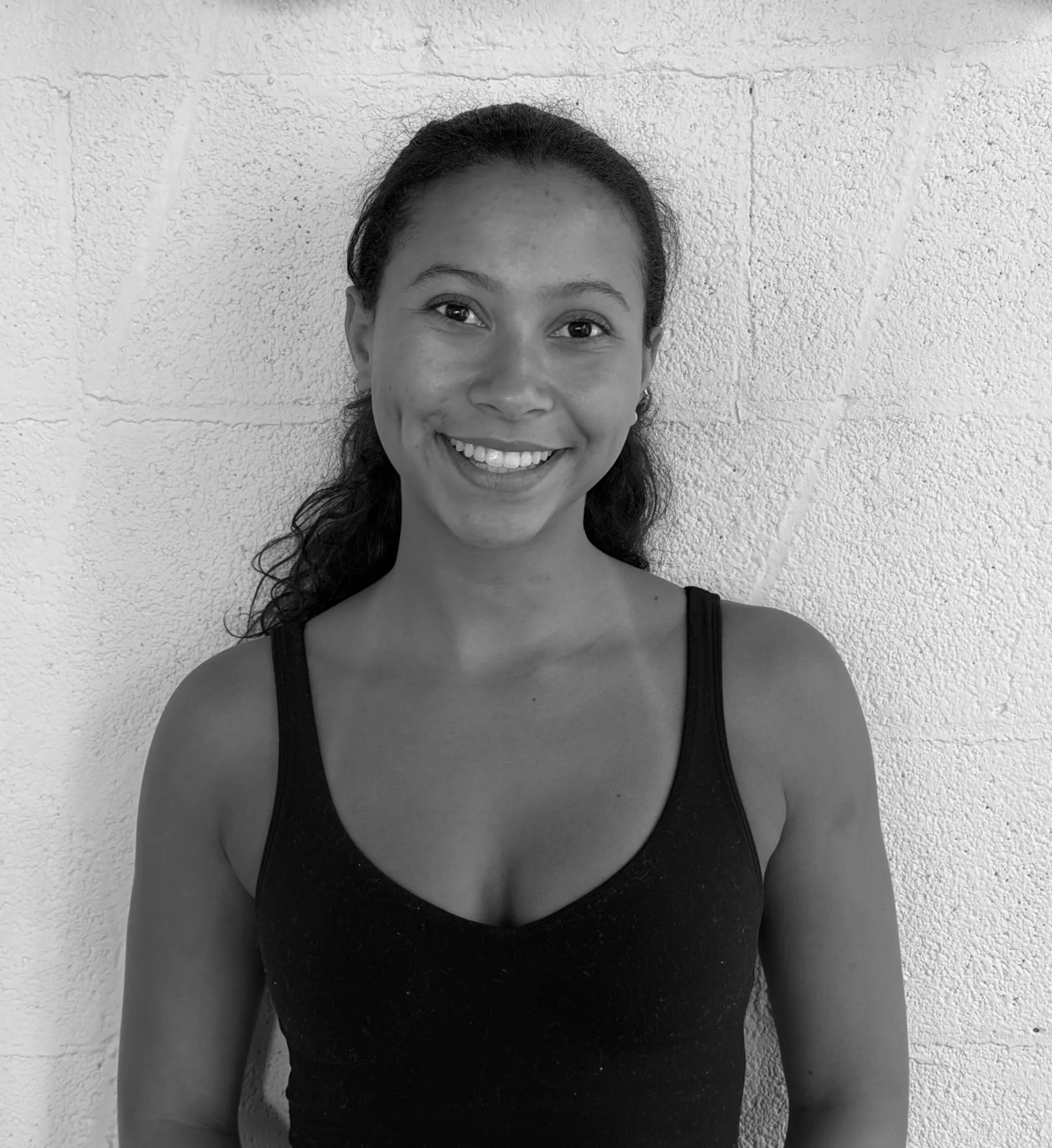 Mia Brown, Pilates instructor at Pilates One, smiling headshot.